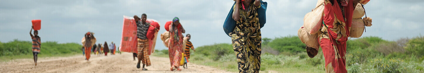 Women, walking with what possesions they can carry, arrive in a steady trickle at an IDP camp erected next to an AMISOM military base near the town of Jowhar, Somalia, on November 12. Heavy rains in Somalia, coupled with recent disputes between clans, has resulted in over four thousand IDPs seeking shelter at an AMISOM military base near the town of Jowhar, with more arriving daily. AU UN IST Photo / Tobin Jones